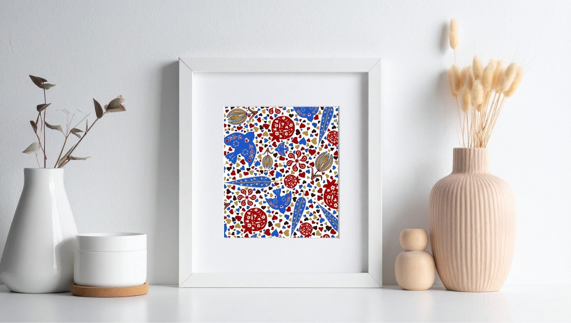 Framed islamic abstract art print with pomegranate and blue bird a white wall with decorative vases and plants.