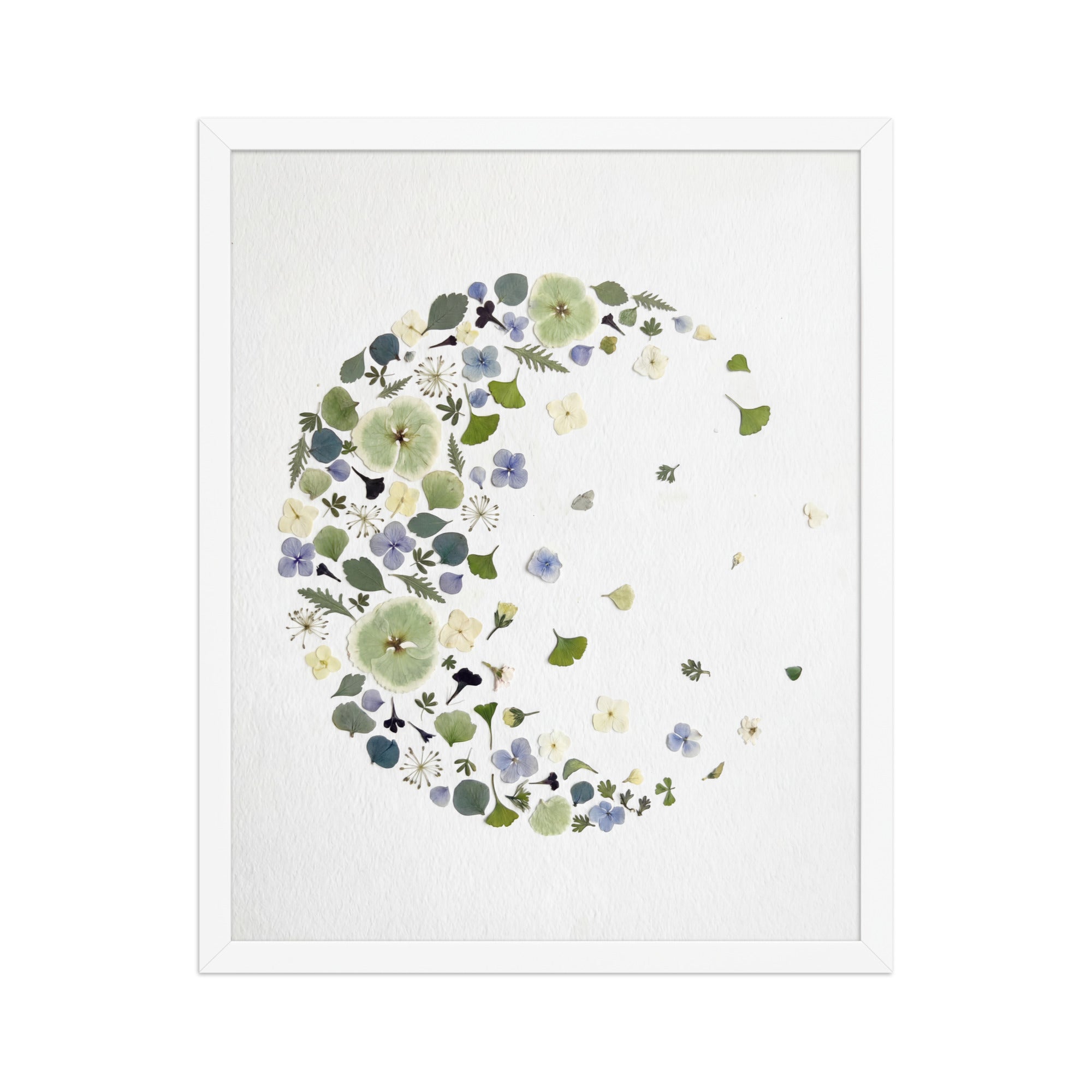 White framed fading moon artwork made from hand-arranged dried flowers, photographed on textured paper with subtle depth and shadow.