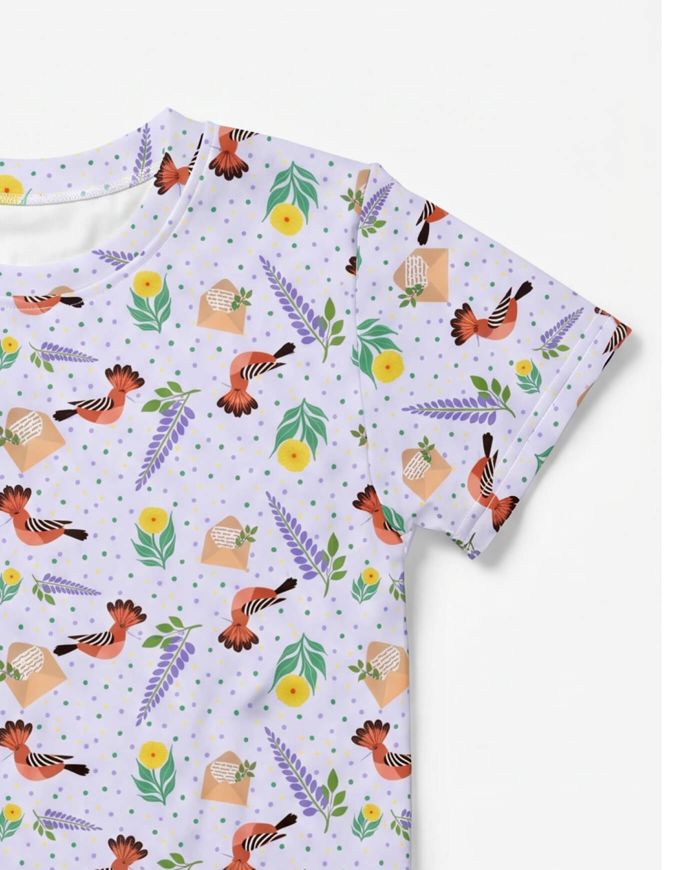 Close-up detail of floral hoopoe bird kids t-shirt showing soft lilac botanical and bird pattern