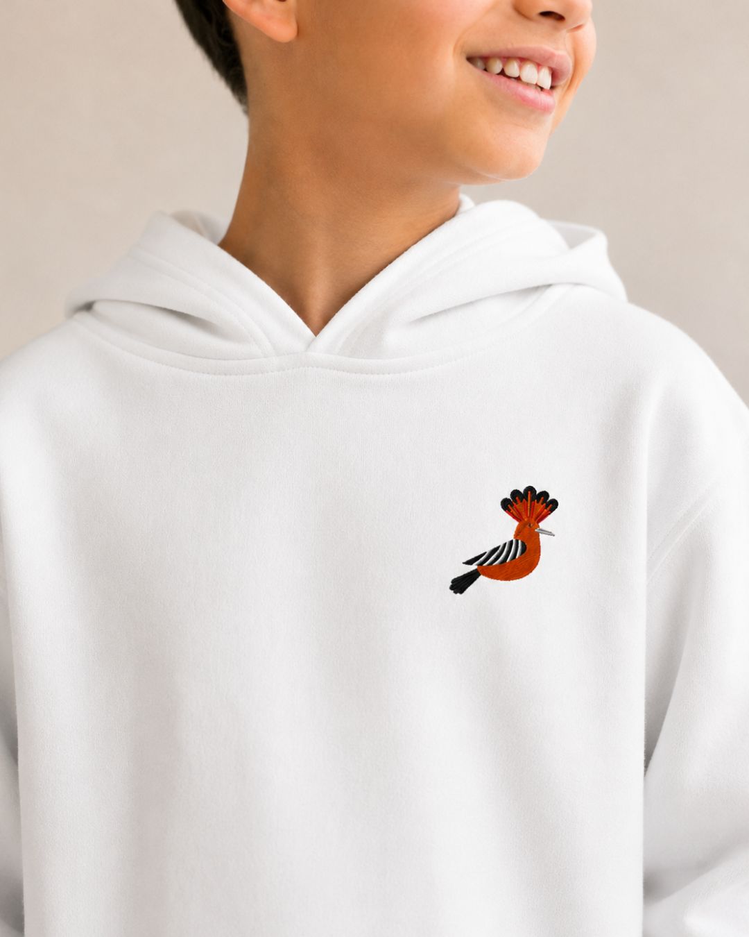 White hoodie with a small embroidered hoopoe bird on the chest for kids and youth.