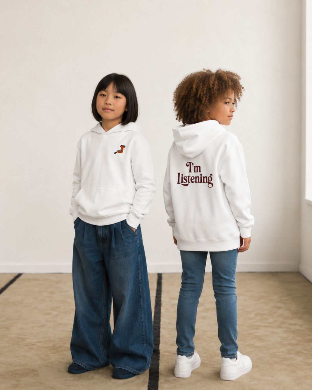 kids wearing white embroidered hoopoe hoodies with minimalist front embroidery and “I’m Listening” back print in modern streetwear styling