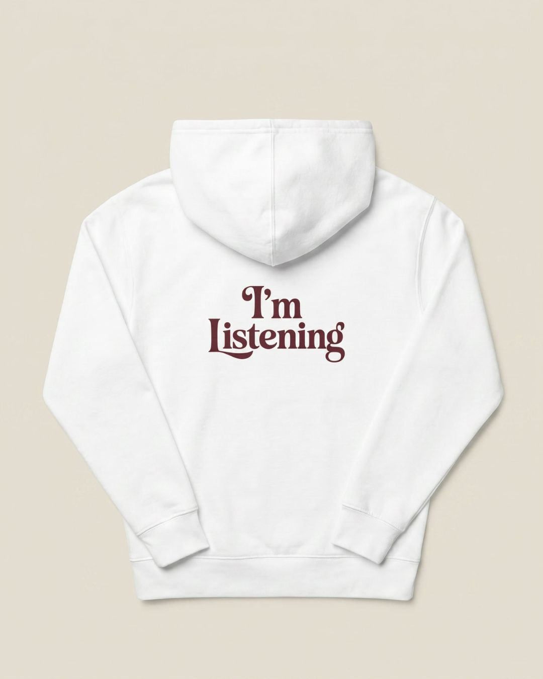 kids white colored hoodie flat lay with burgundy “I’m Listening” back graphic