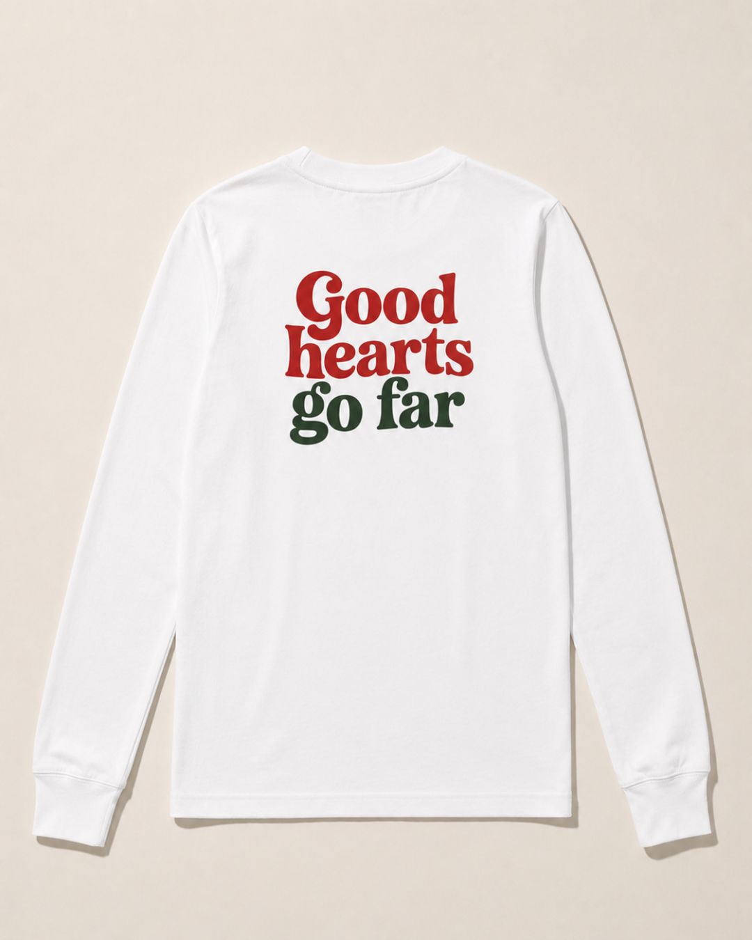 Kid’s white long sleeve shirt with oversized “Good hearts go far” retro graphic back print