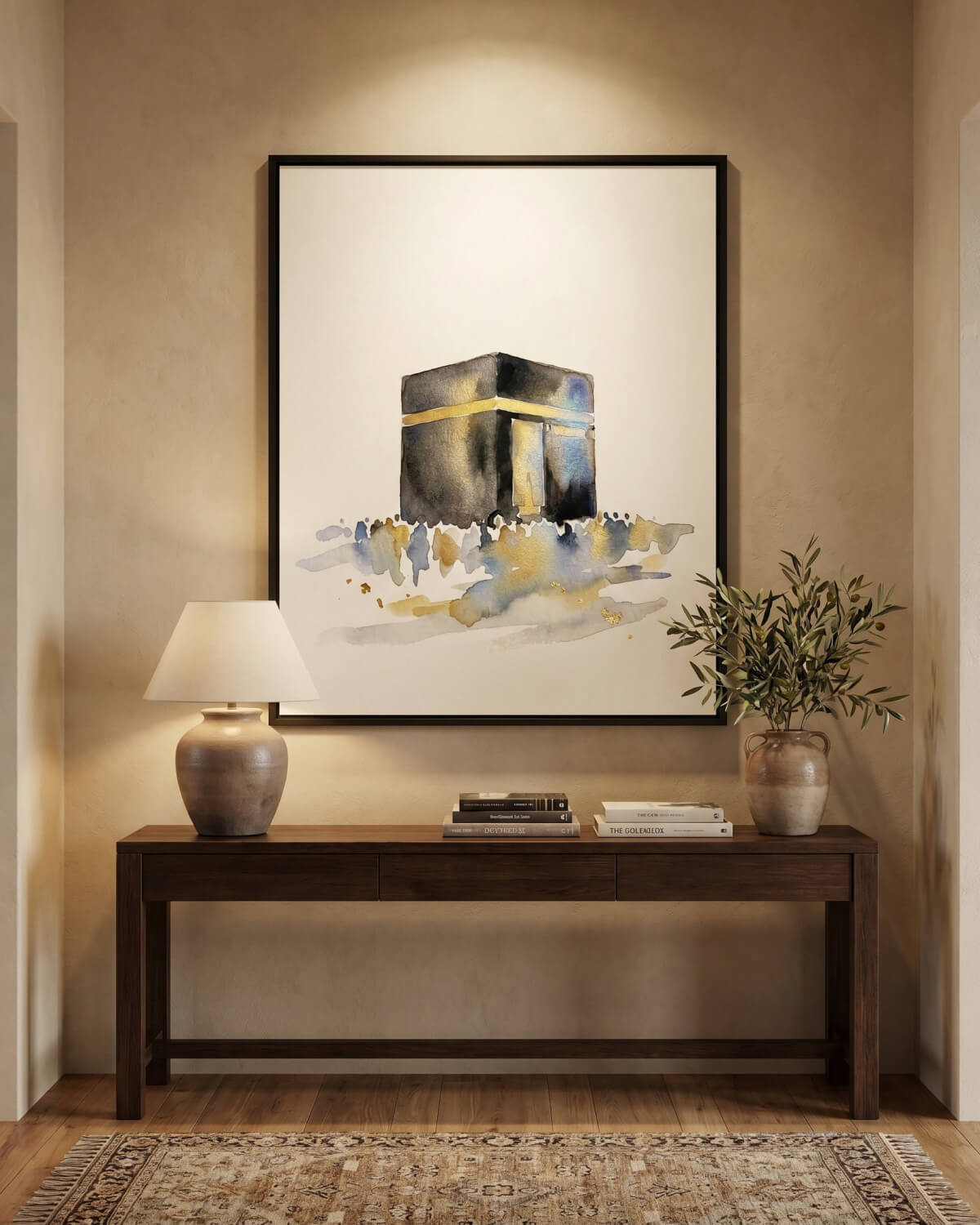 Minimal Kaaba wall art print in a black frame displayed above a wooden console in a warm Islamic centre or prayer room inspired interior.