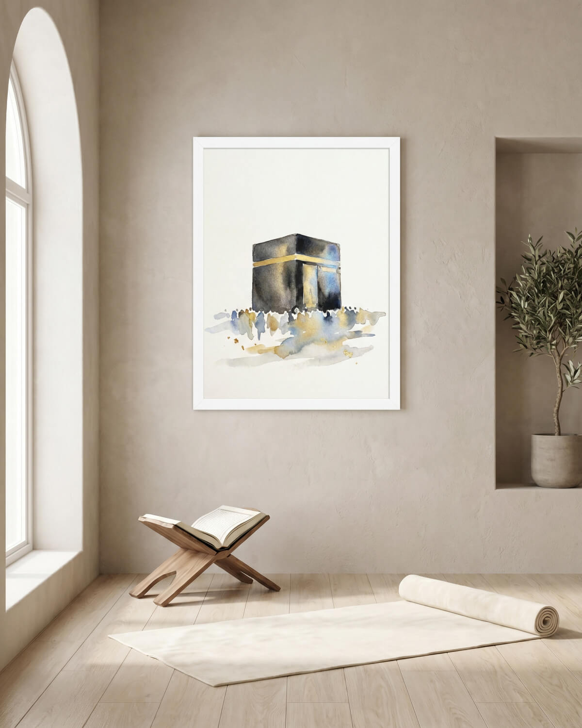 Minimal Kaaba wall art print in a white frame displayed in a calm prayer room with a Quran stand, soft neutral walls and Scandinavian-inspired Islamic interior styling.