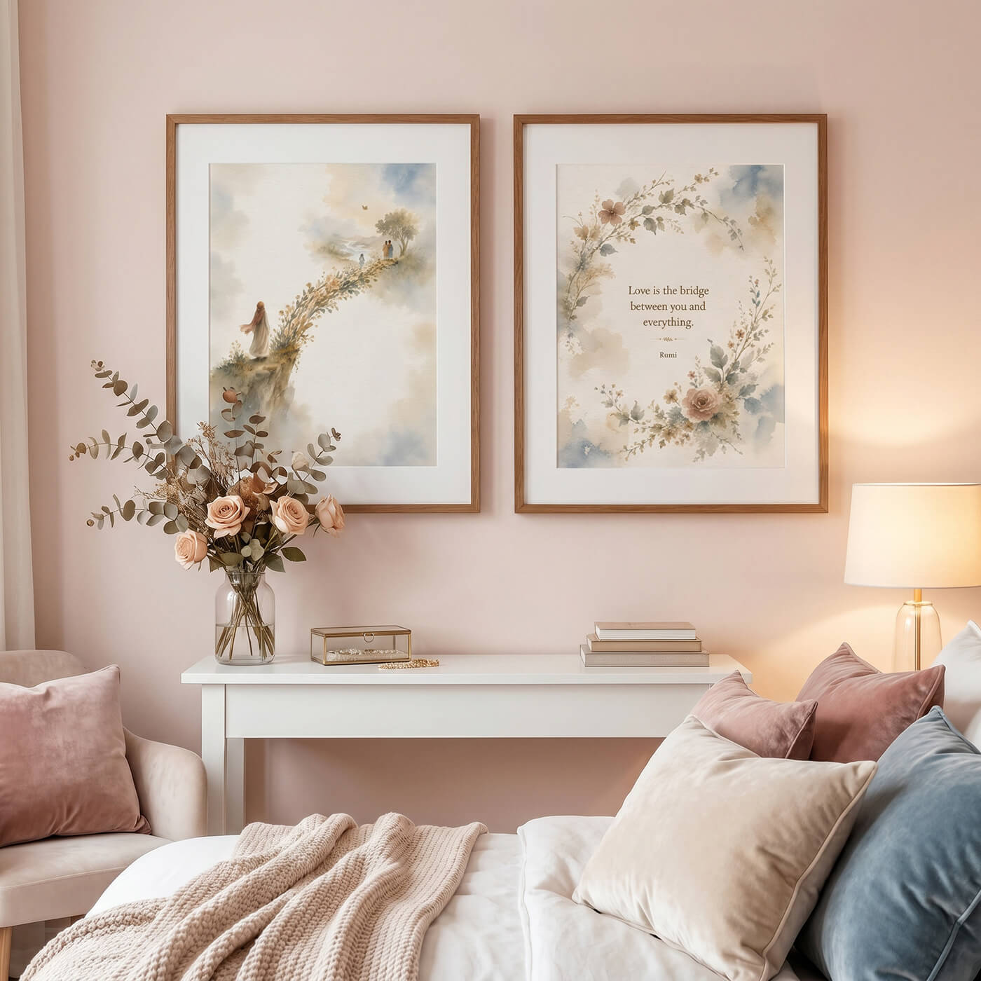 Two framed Rumi-inspired watercolor wall art prints in white washed oak frames above a soft neutral bedroom setting with pink cushions and flowers.